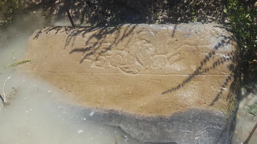 A stone tablet found half submerged in a local canal. 